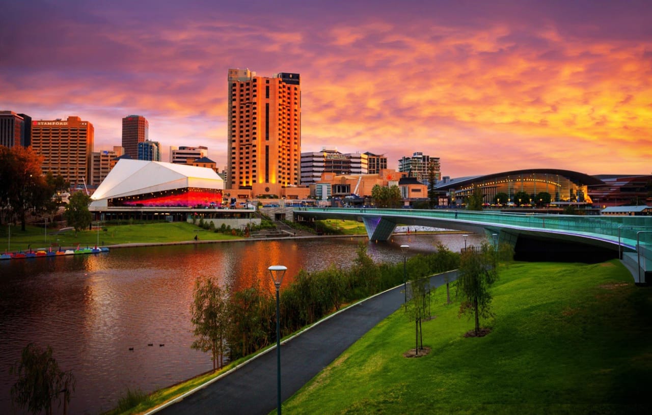 Adelaide at sunset, the Torrens river and Festival Centre under a pink and orange sky