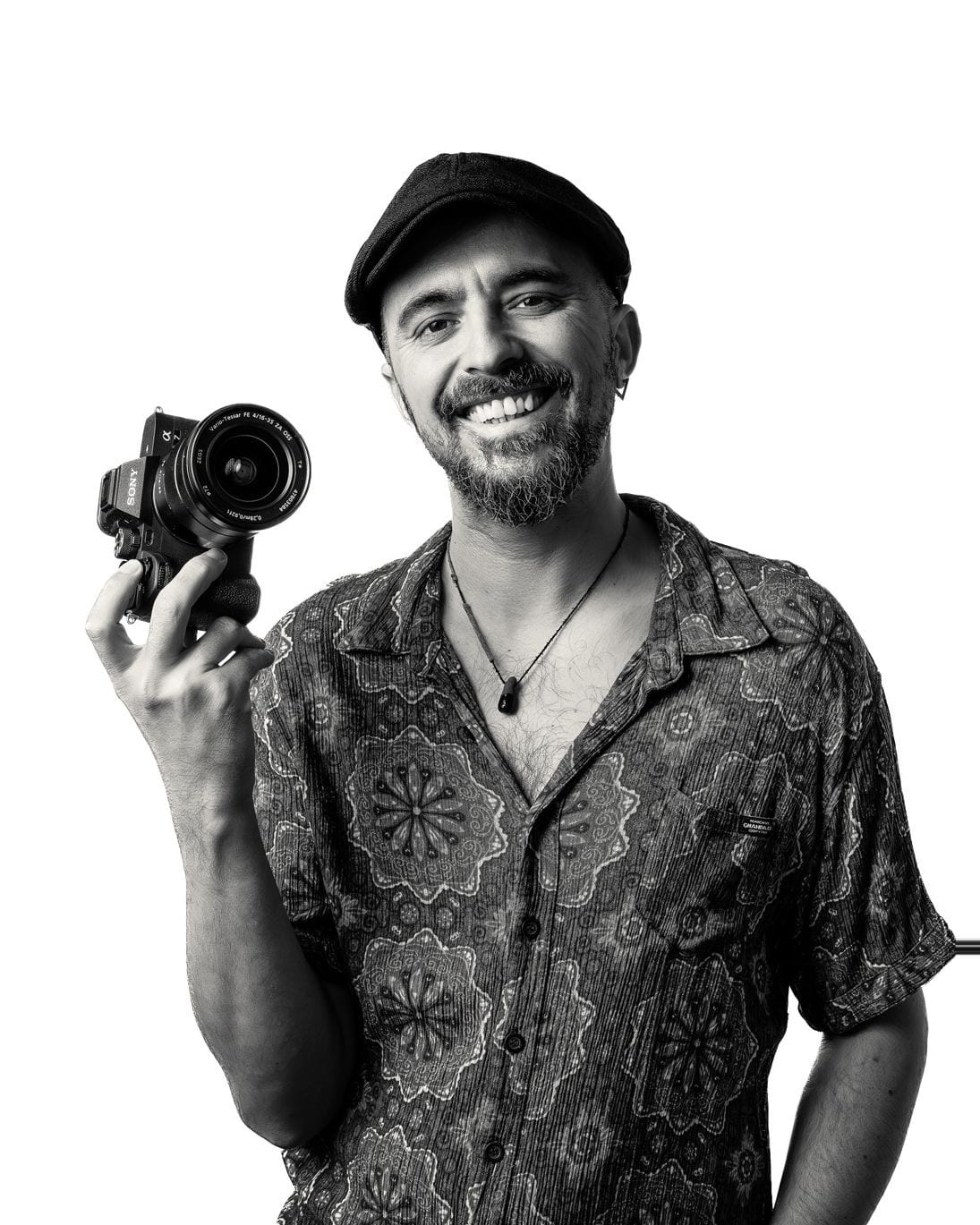 Serkan, Adelaide videographer, smiling with a camera