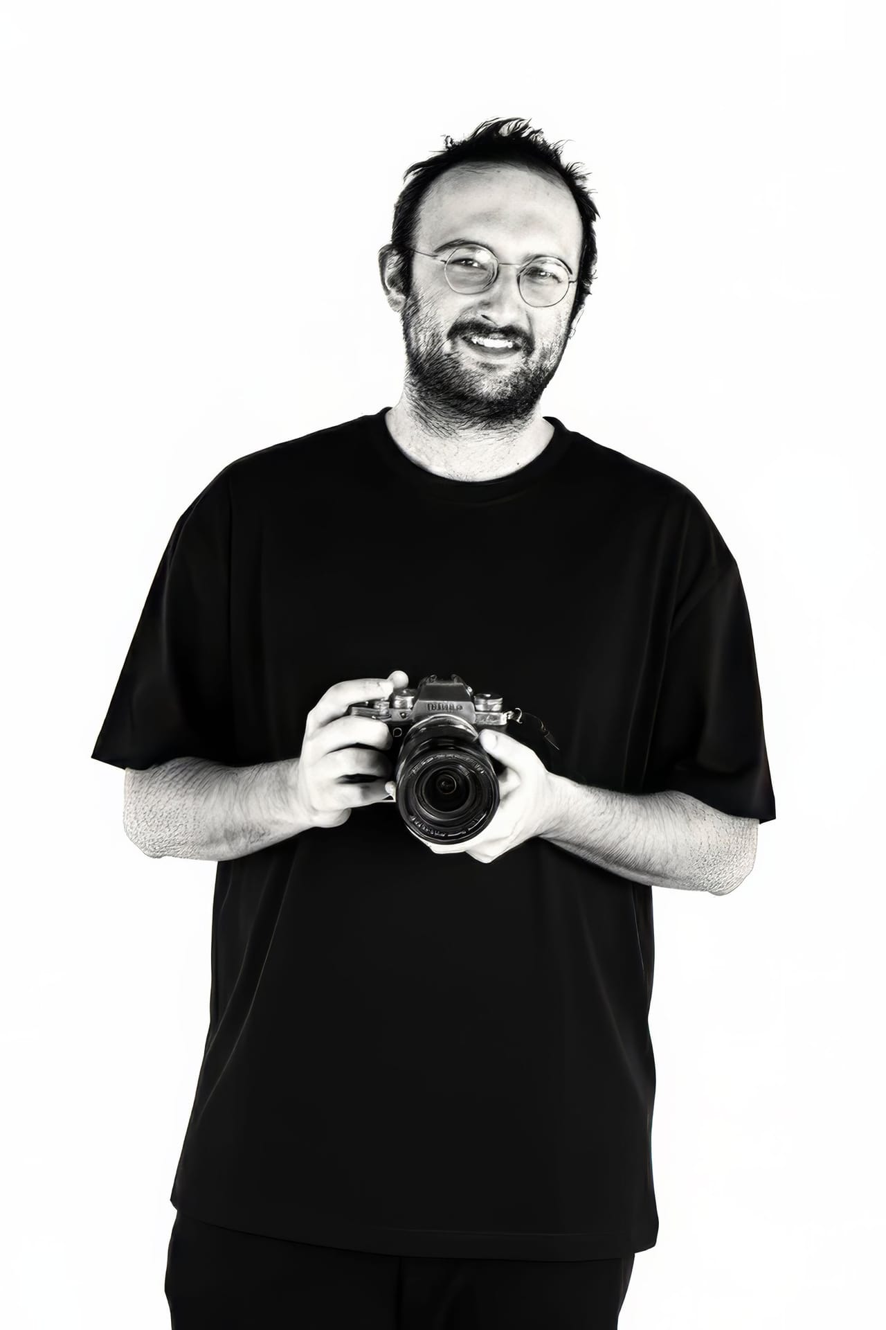 Jay holding a camera, black and white portrait