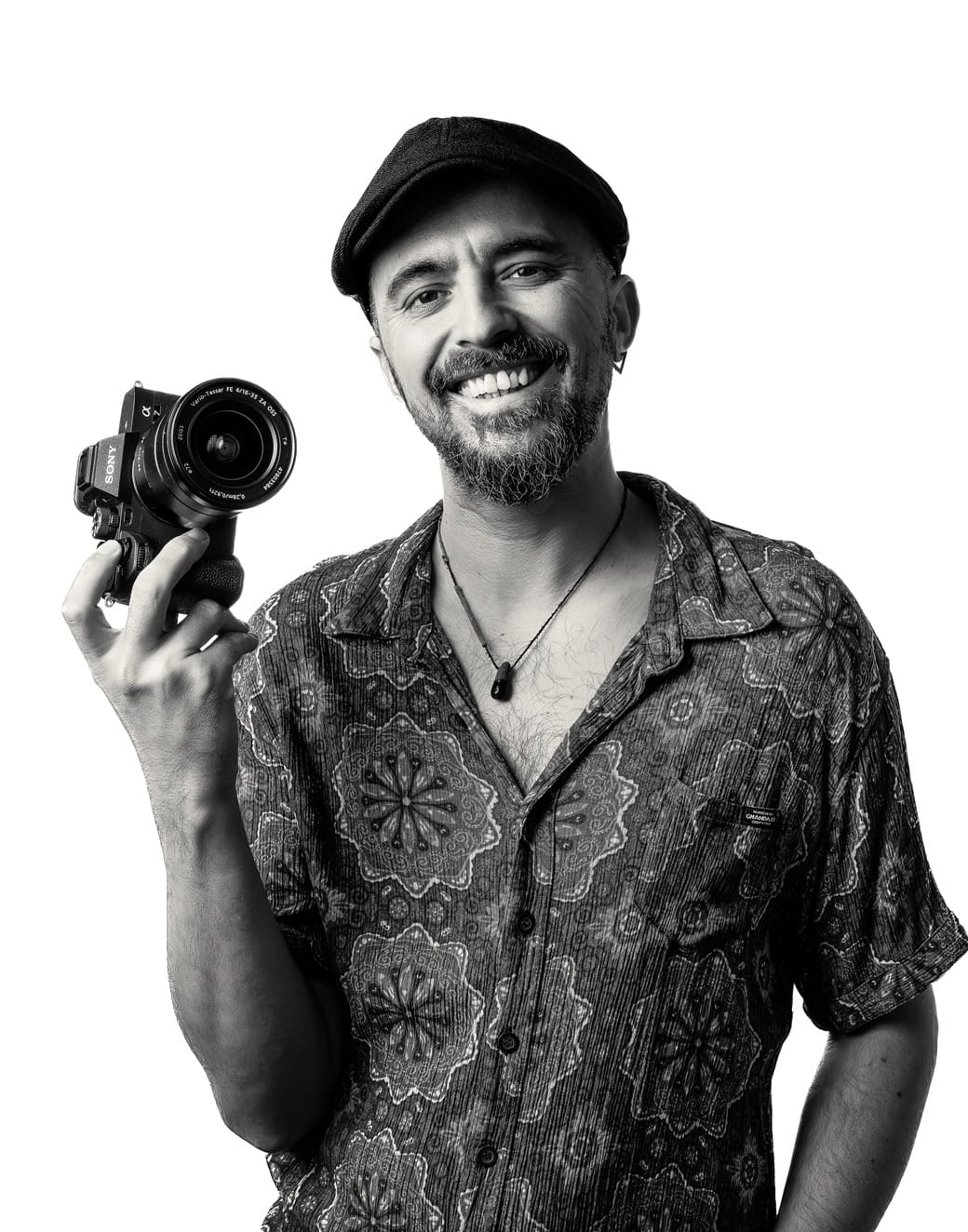 Serkan, Adelaide videographer, smiling with a camera