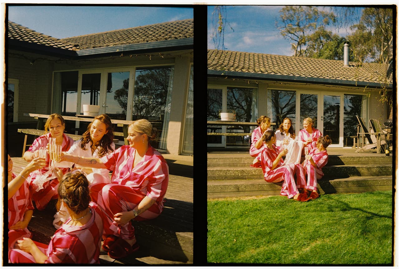 Two half frames side by side: the bridesmaids in striped pyjamas on the timber deck of a tiled-roof house with tall glass doors, the lawn below, on 35mm film