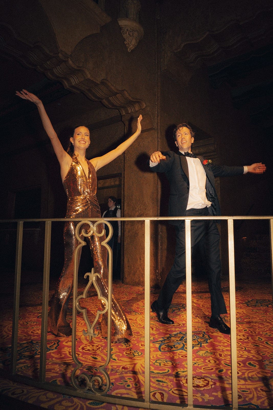 Kira and Nick dancing on a balcony above the ballroom