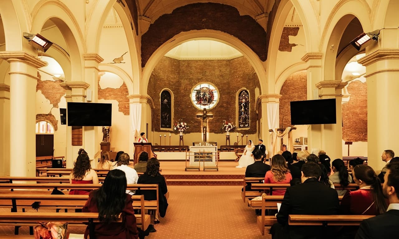 The ceremony from behind the guests, looking down the aisle to the altar