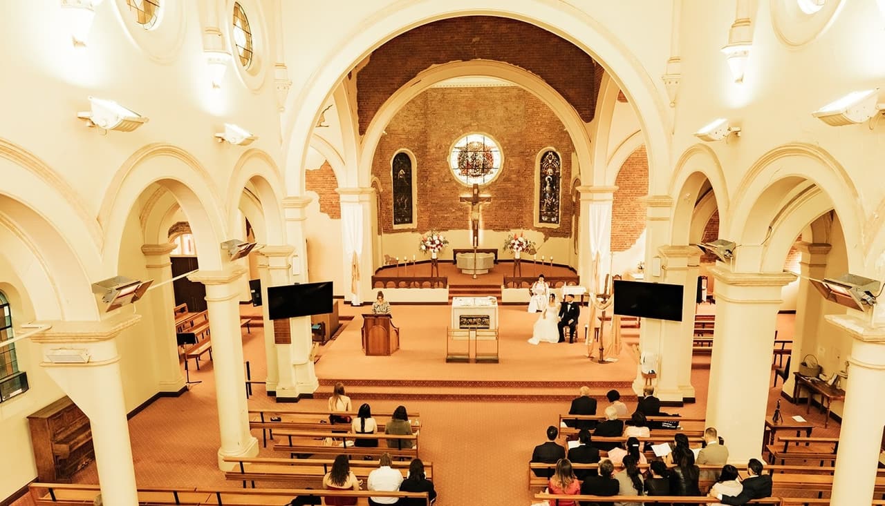 The whole church from above during the ceremony, the couple small in front of the altar
