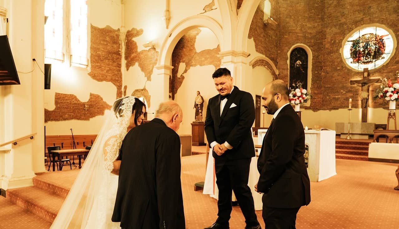 Ashley’s dad bringing her to Bryan at the front of the church