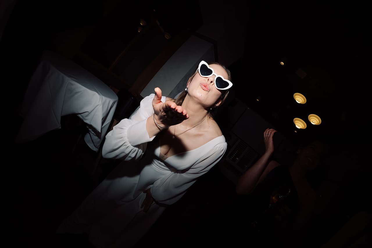 Bianca dancing in heart-shaped sunglasses at the reception