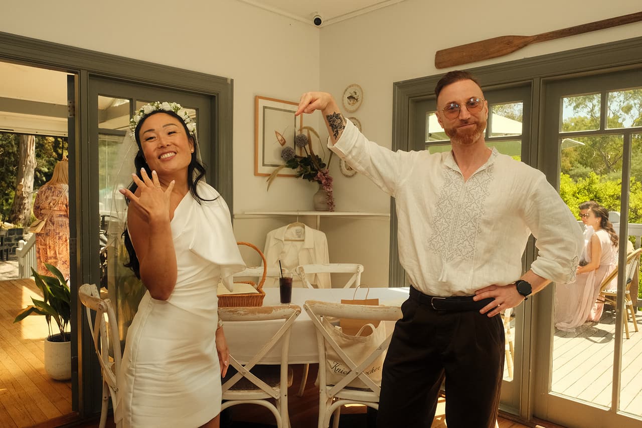Cecile showing off her ring as Stefan strikes a pose inside the boathouse