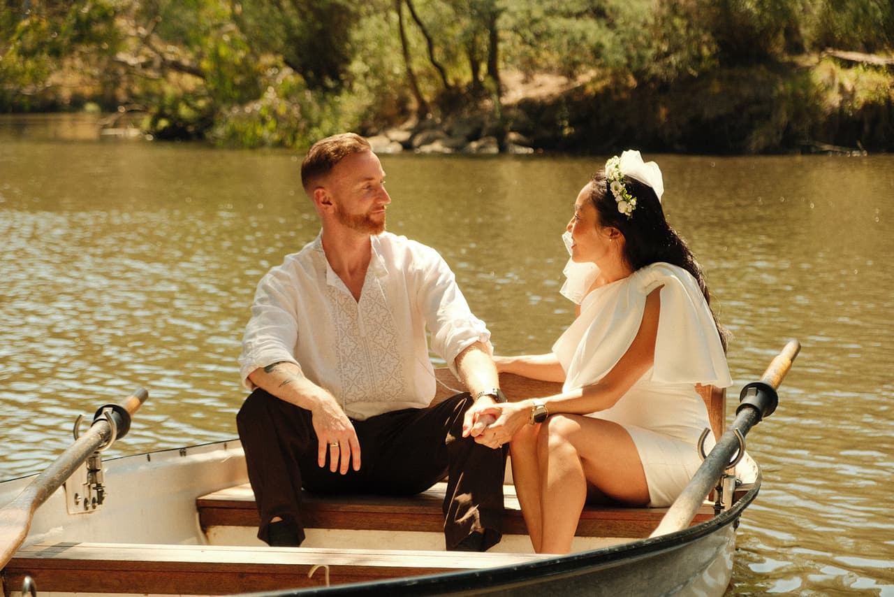 Cecile and Stefan laughing in their rowing boat in the middle of the river
