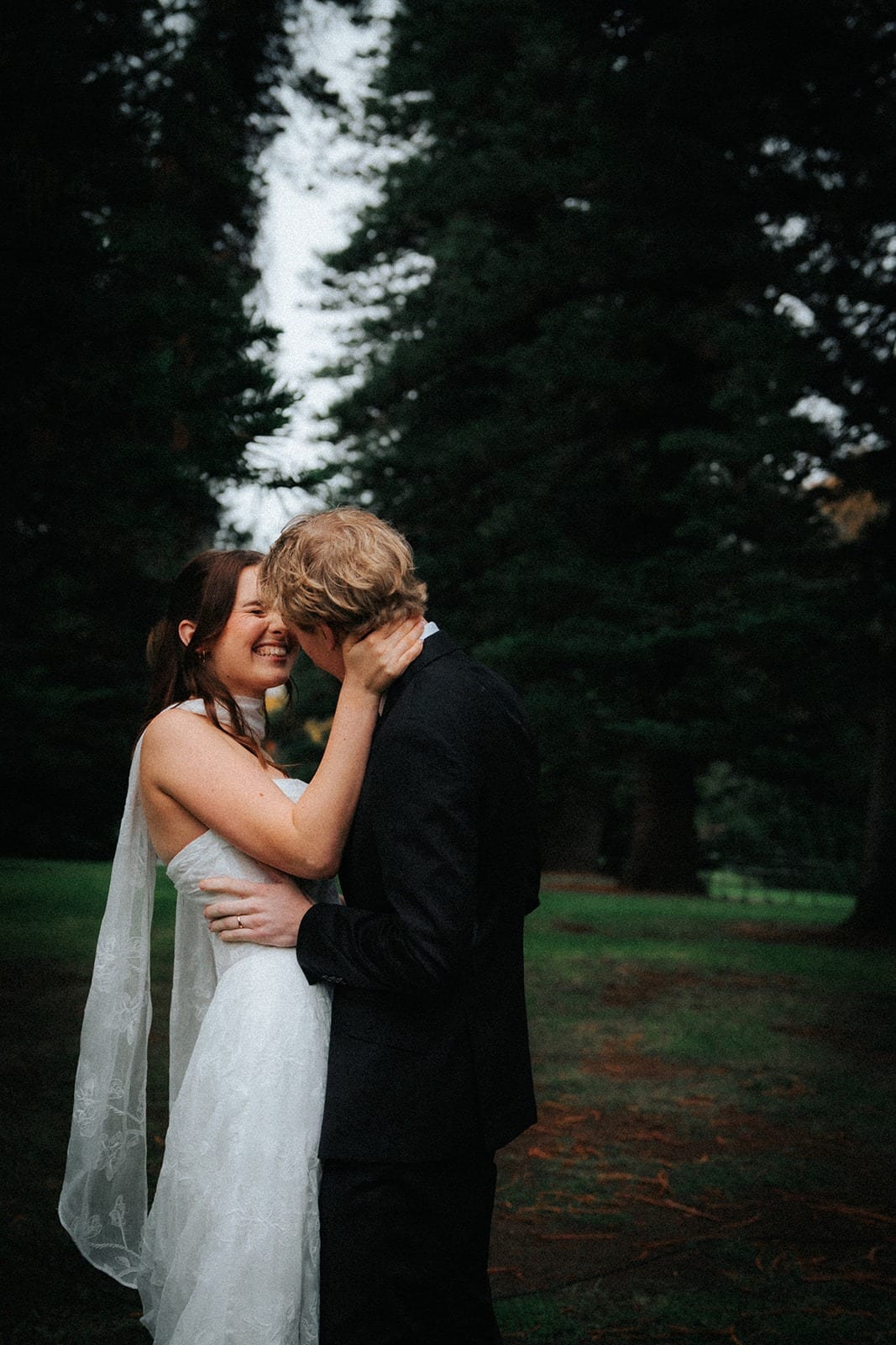 Eli kissing Charlotte’s forehead under the pines