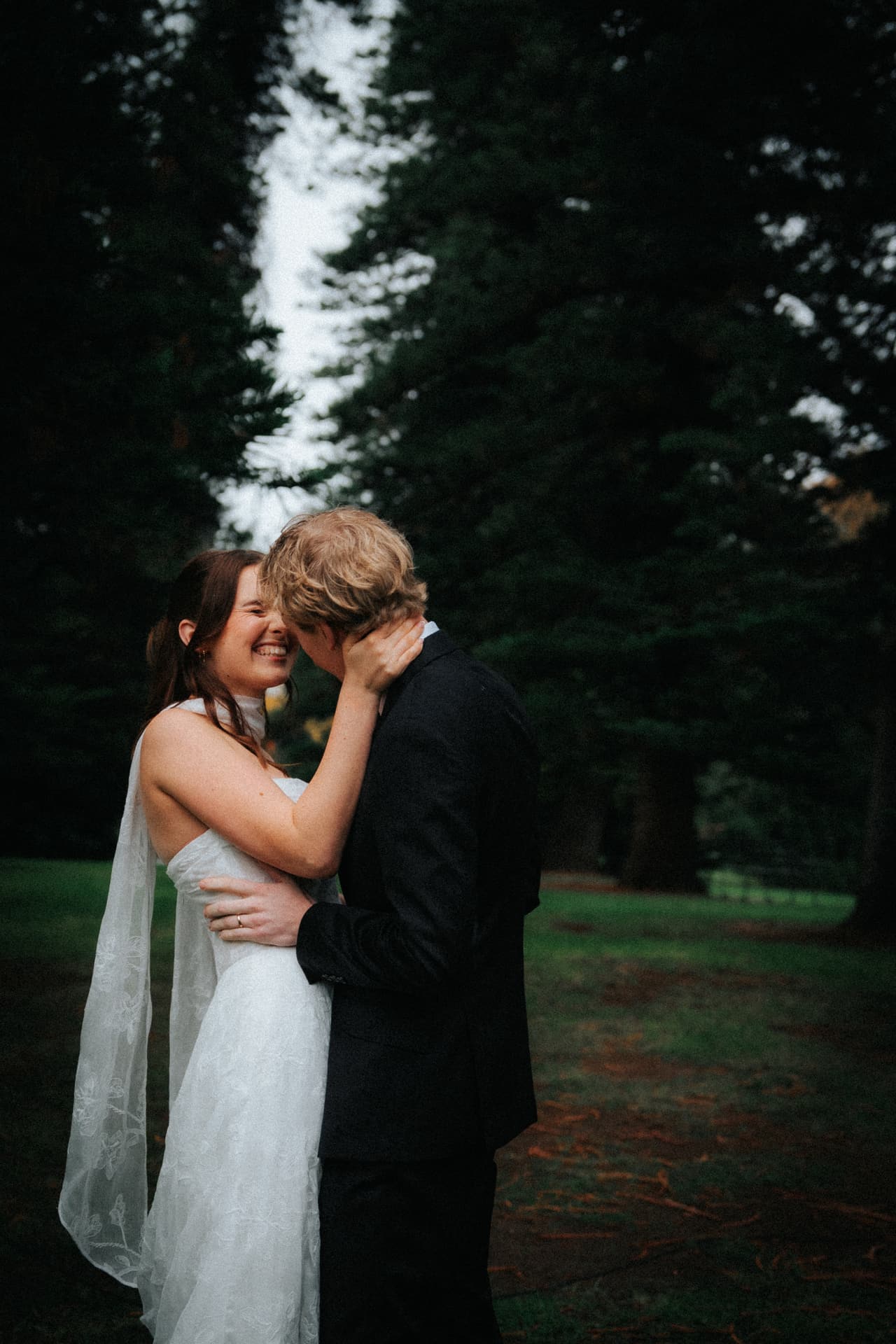 Eli kissing Charlotte’s forehead under the pines