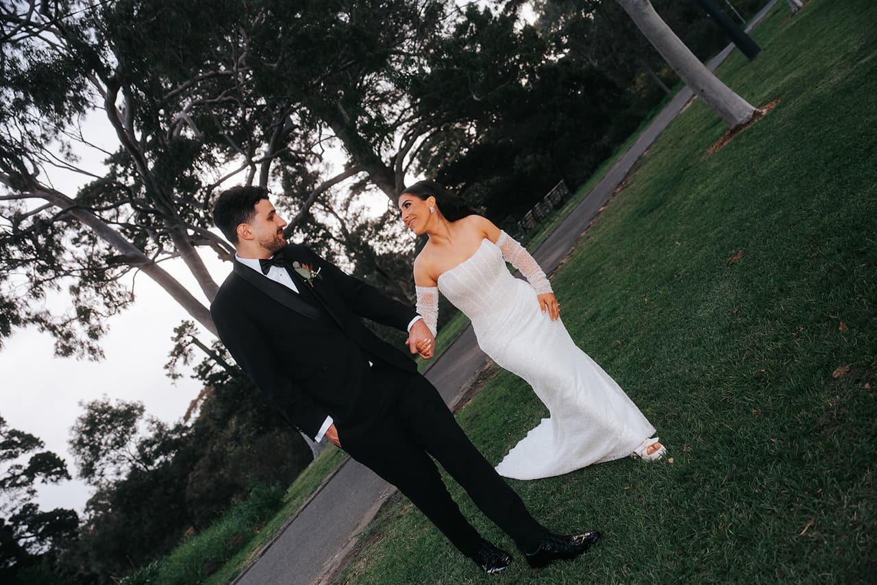 George and Tia dancing on a grassy slope, the frame tilted with their movement