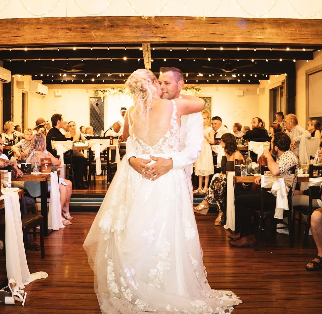 Jenna and Nick’s first dance on the timber floor of the reception hall under the chandeliers
