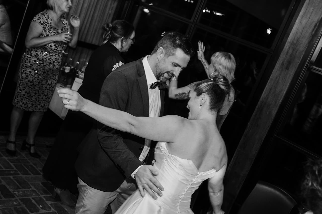 Black and white photo of Jessica and Max dancing together in the crowd