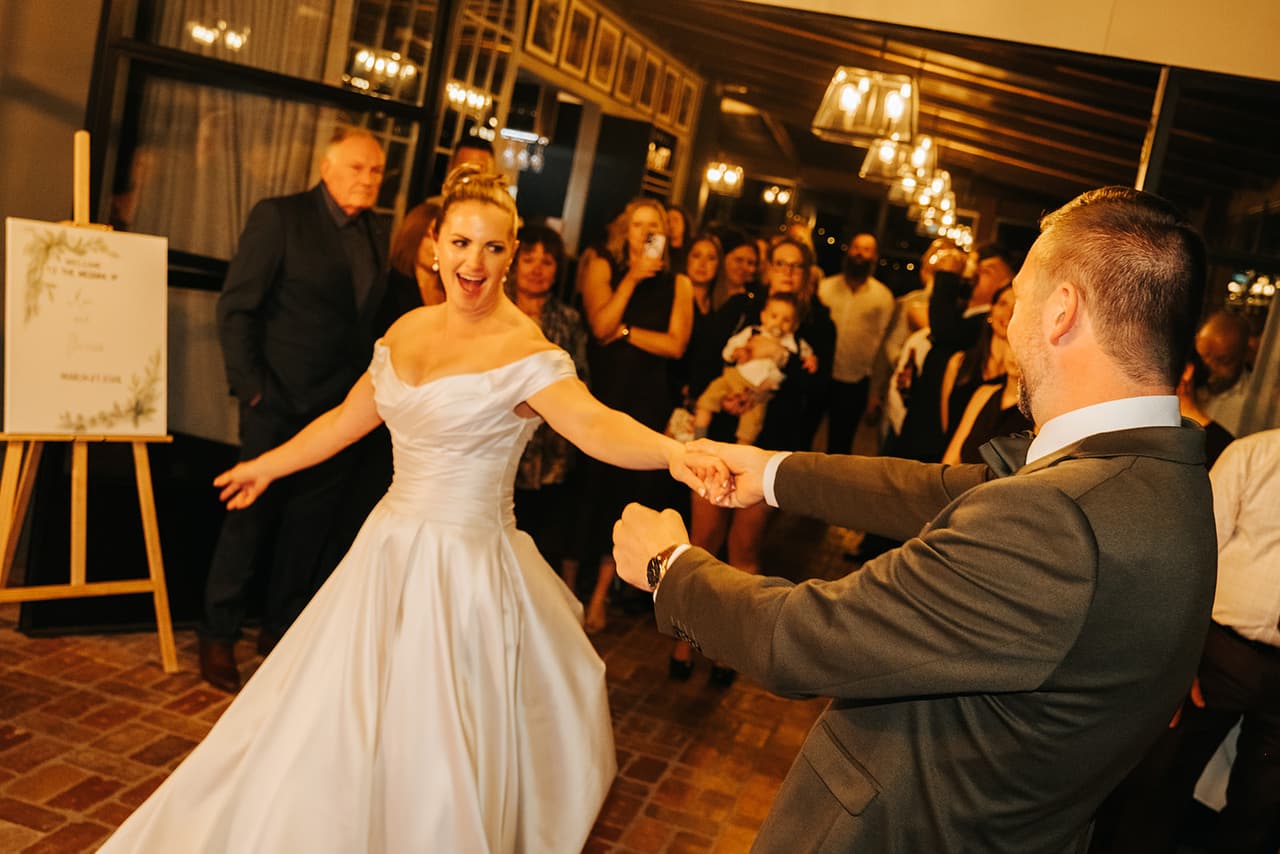 Jessica laughing as Max spins her out during their first dance