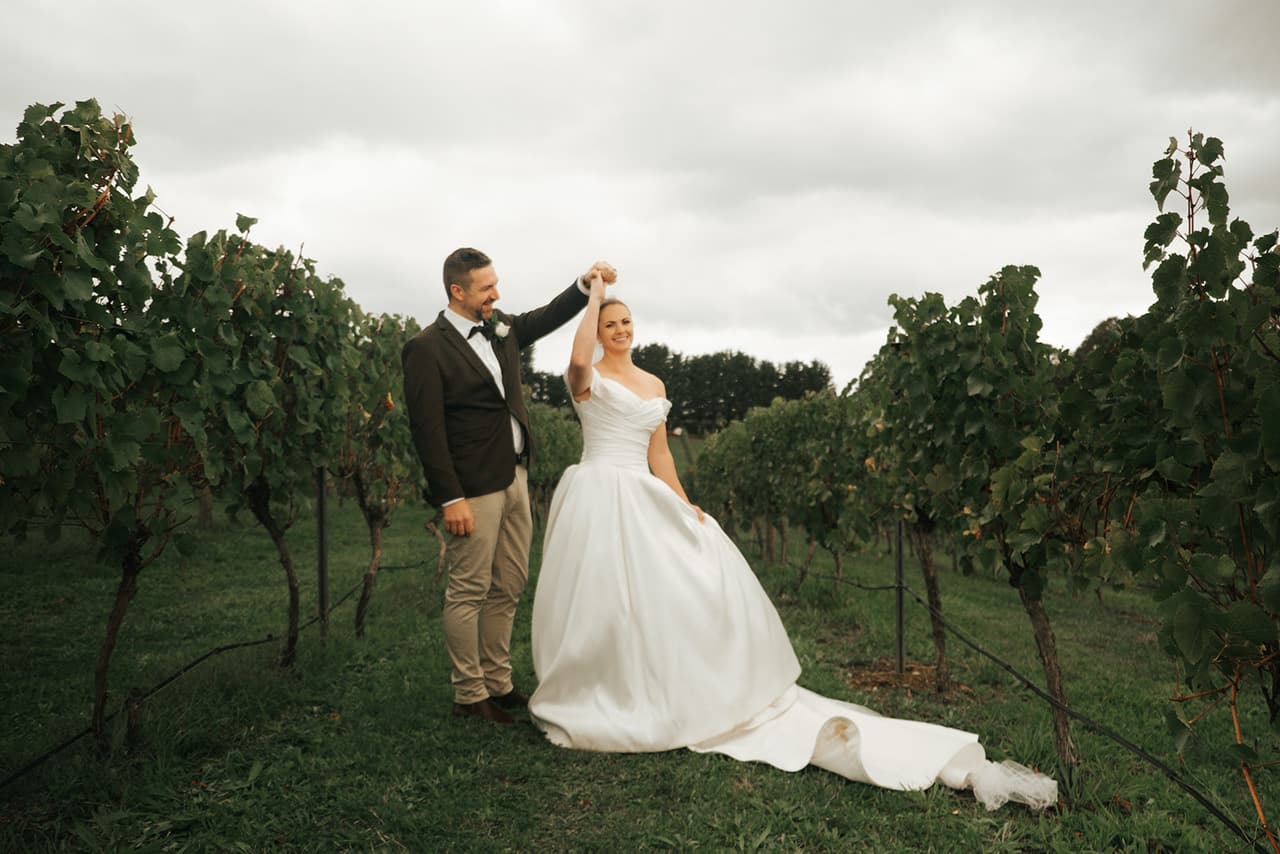 Max twirling Jessica between the rows of vines
