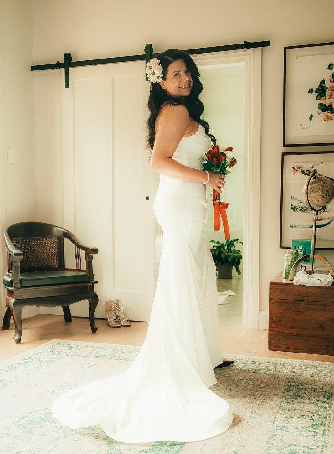 Joanna in her gown with its train spread across the floor of a bright room