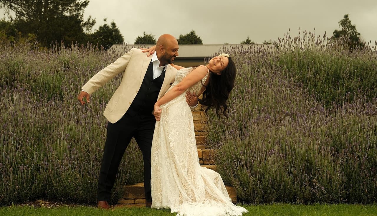 Krish dipping Joanna on the lawn in front of the lavender