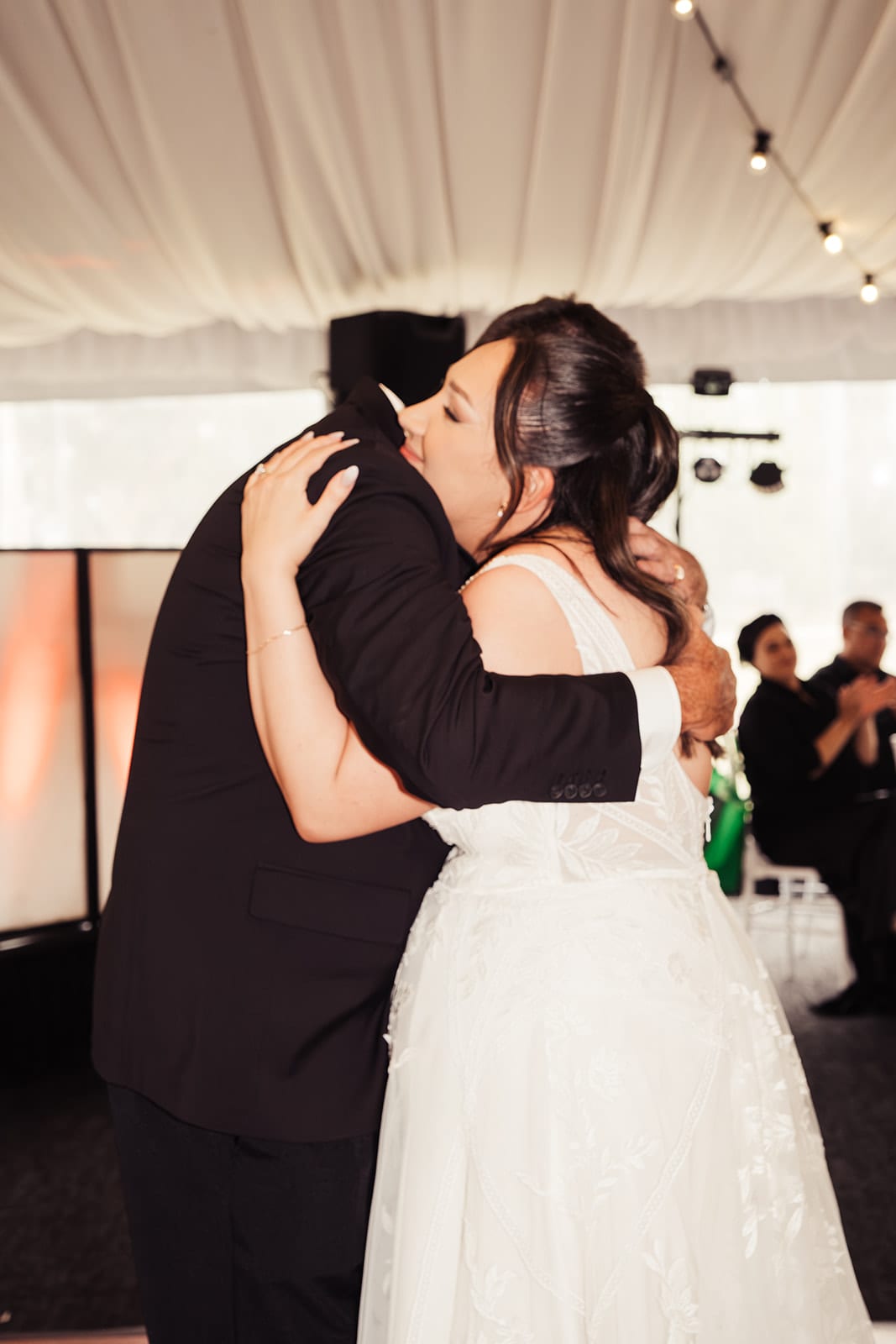 Karina hugging her dad during their dance