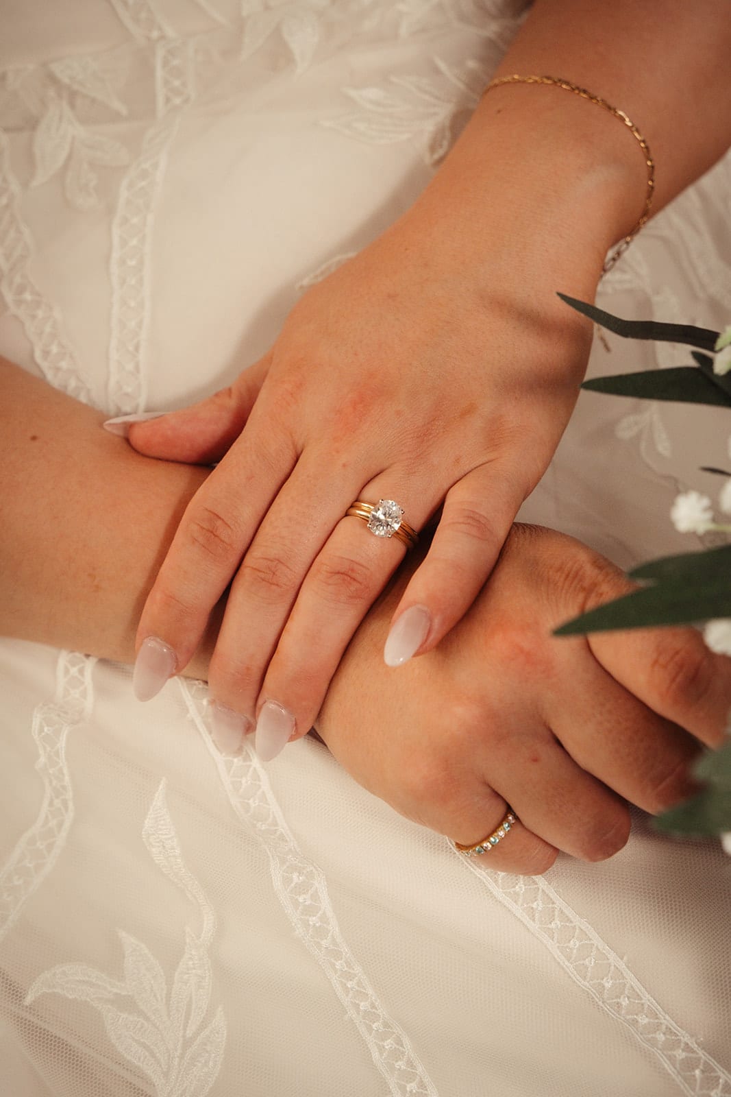 Karina's hand over Bronson's, their new rings side by side
