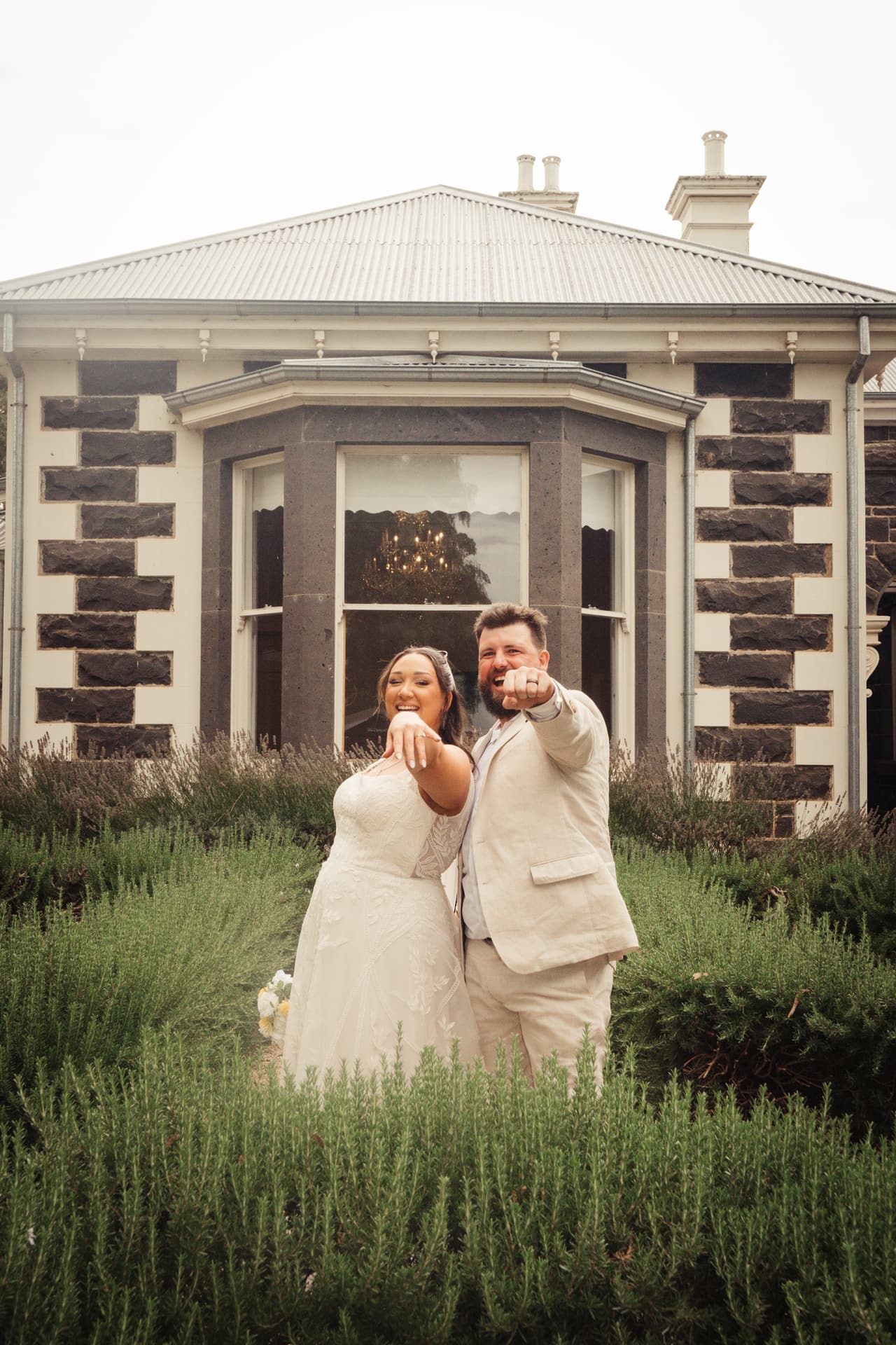 Karina and Bronson in front of the bluestone homestead and its white veranda