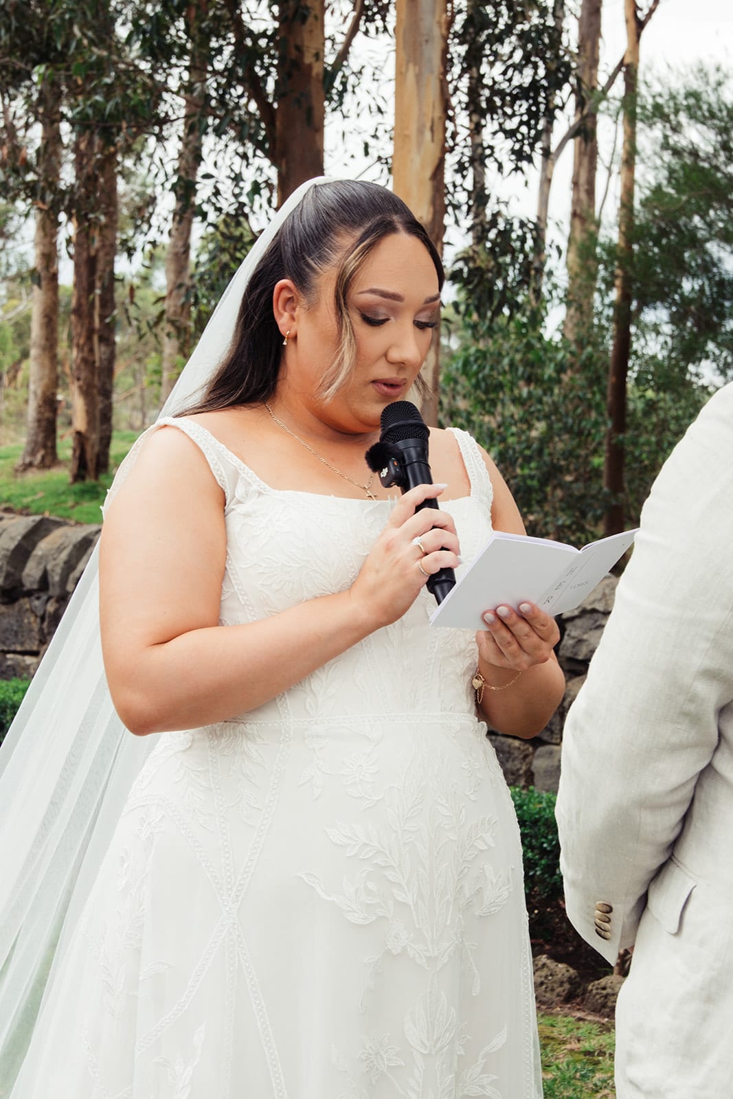 Karina reading her vows into the microphone