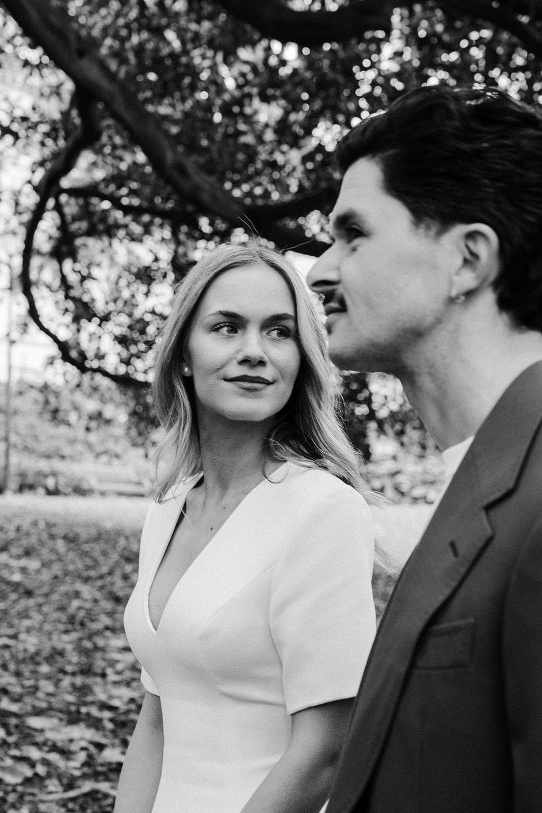 Black and white photo of Karina and Chris close together under a tree