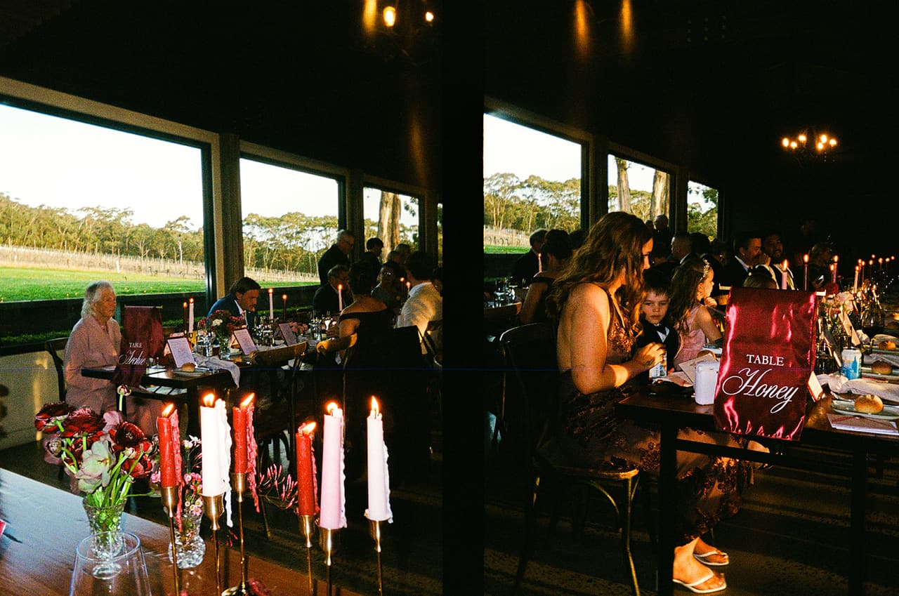 Two half frames side by side: guests at dinner by the big windows over the vines, red and pink candles on the tables, on 35mm film