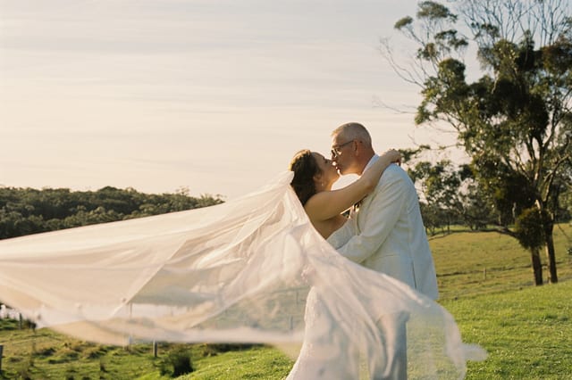 Kristie's veil lifting in the wind as she and Gareth kiss on the hillside, on 35mm film