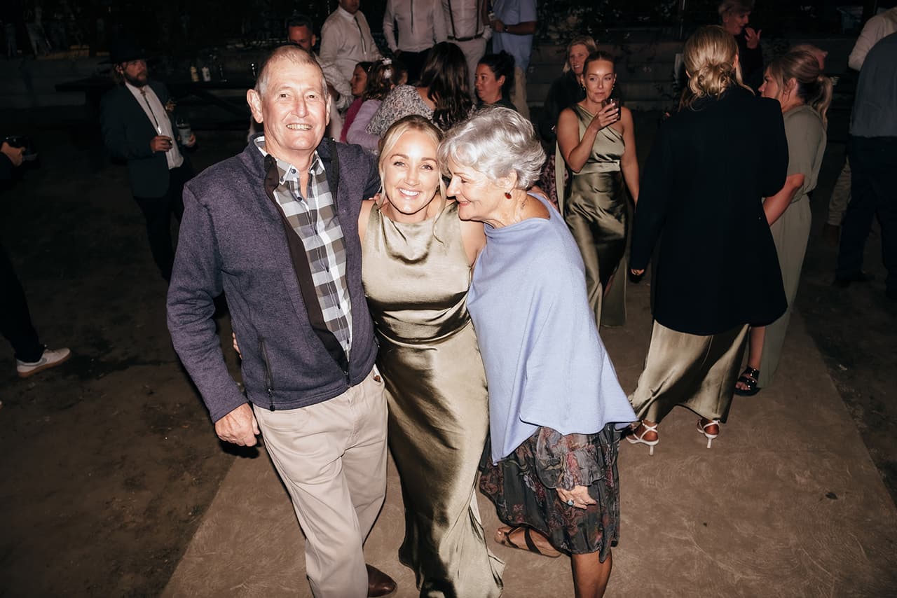 Guests dancing arm in arm on the dance floor