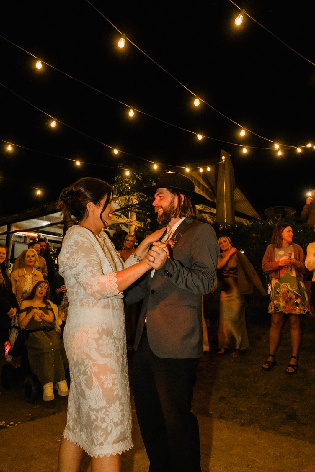 Lana and Todd dancing under the festoon lights at night