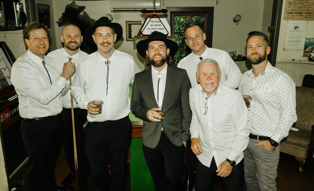 Todd and his groomsmen sharing a drink inside the old pub before the ceremony