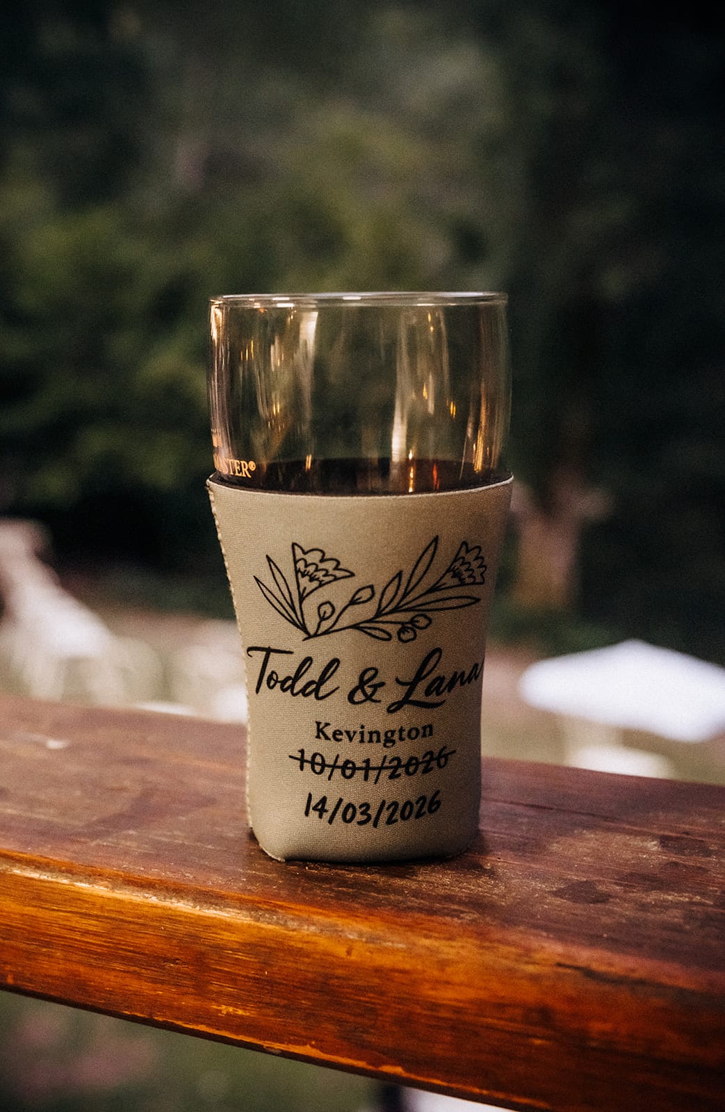 A stubby holder printed with Todd and Lana, Kevington, the old date of 10 January crossed out above the new one, 14 March 2026
