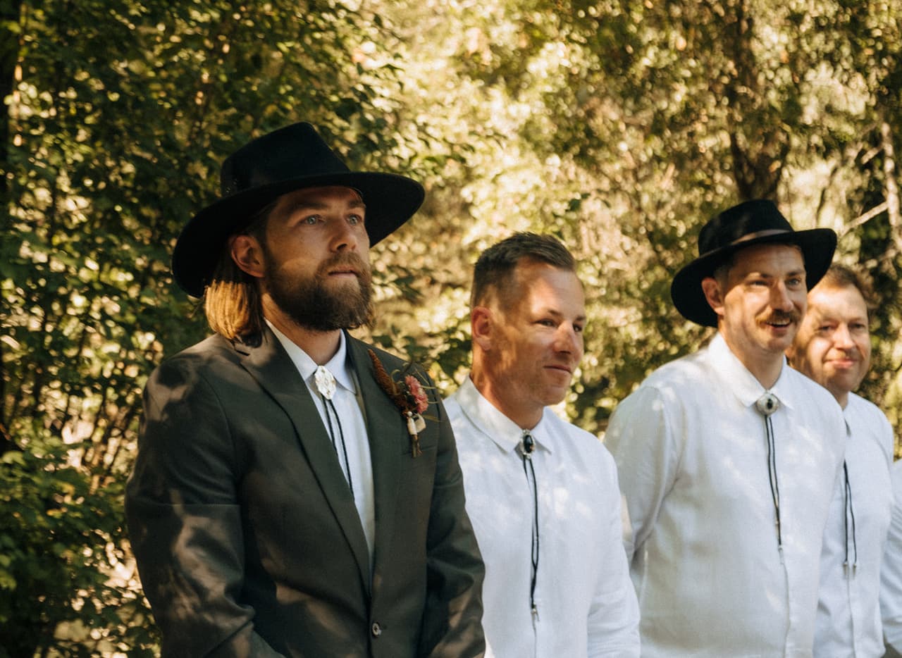 Todd in his wide-brimmed hat watching Lana arrive, his groomsmen beside him