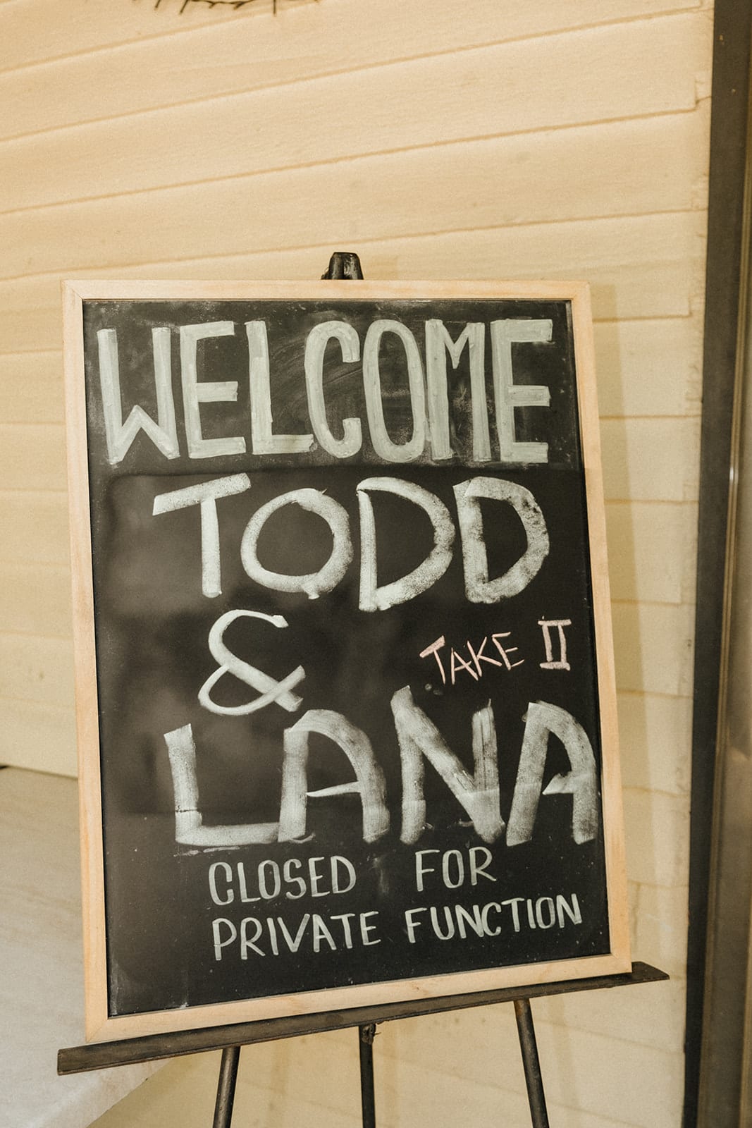 A chalkboard on an easel welcoming Todd and Lana, Take II, with the hotel closed for a private function