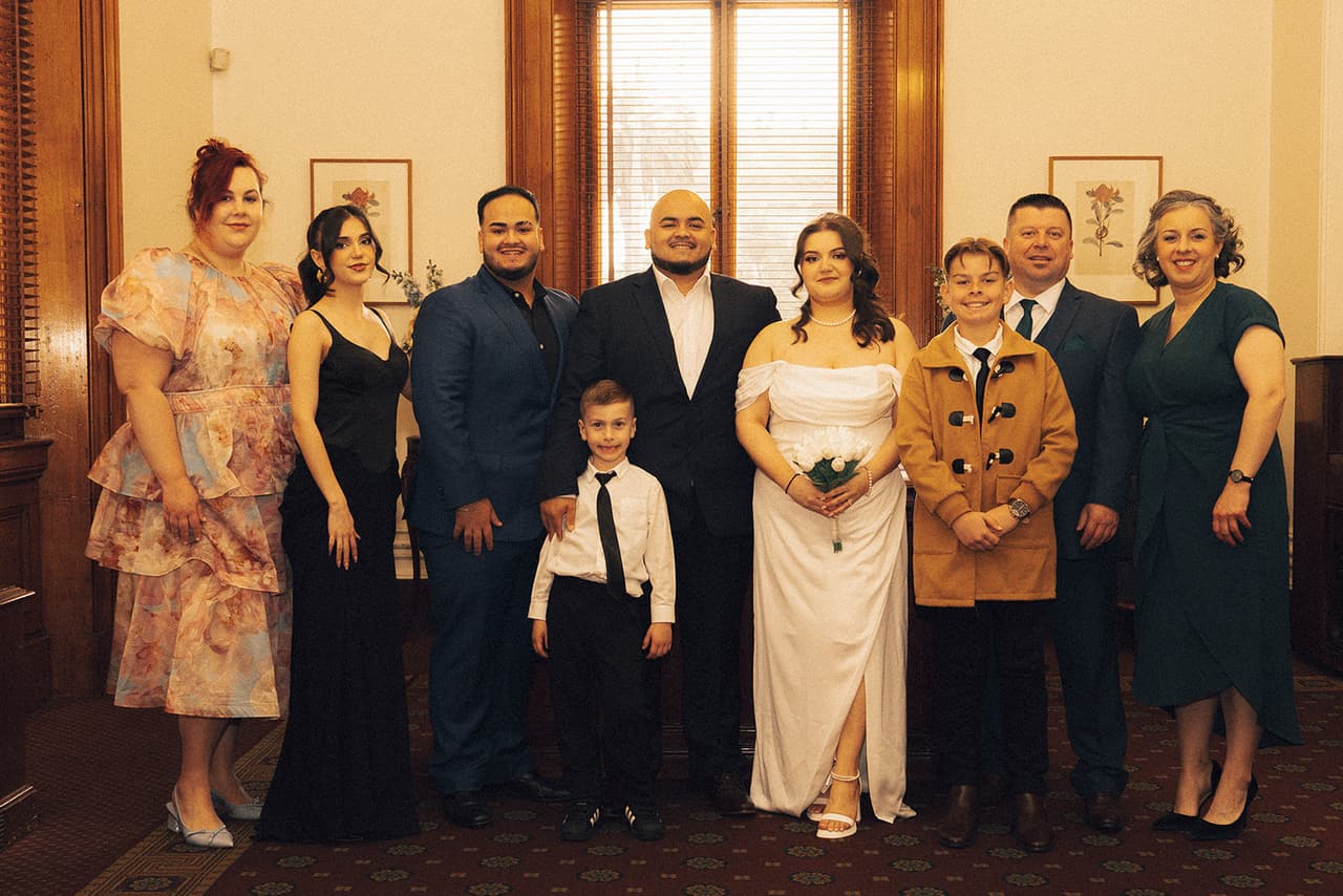 Martina and Diego with their family and friends in the ceremony room