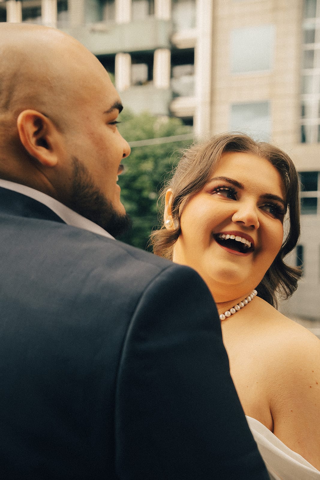 Martina laughing over Diego's shoulder