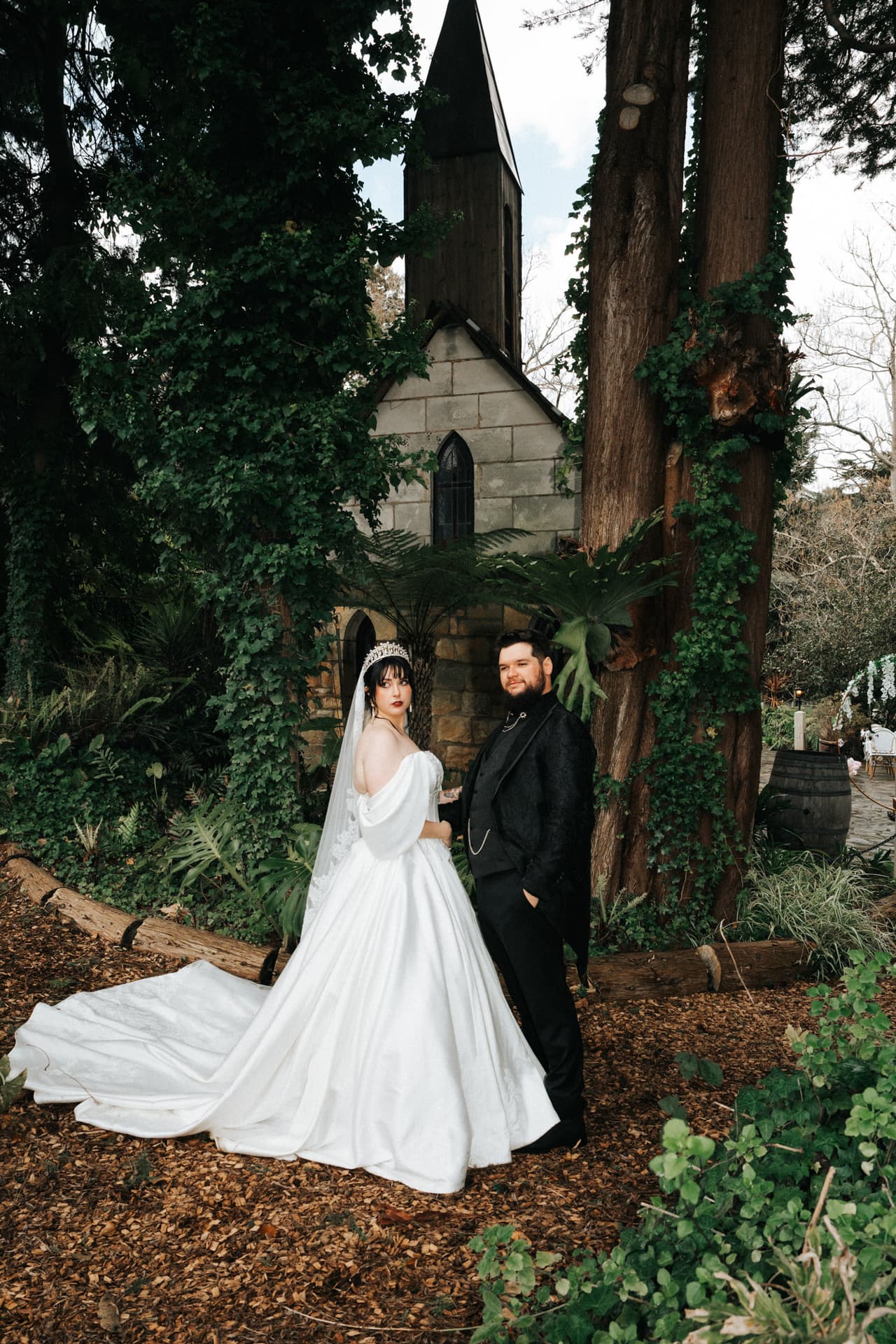 Porscha and Jordan in the woodland in front of the small stone chapel at The Manor