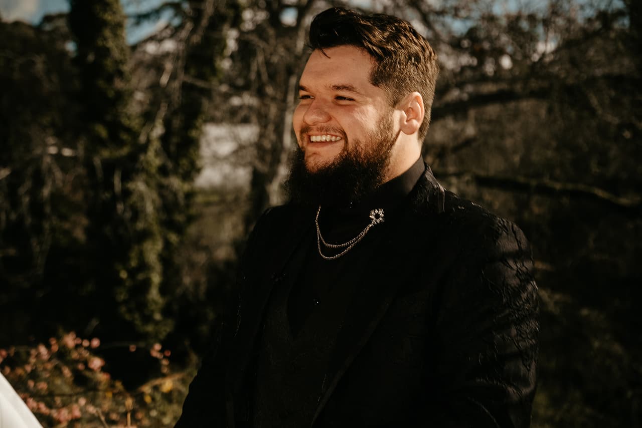Jordan laughing in his black brocade jacket