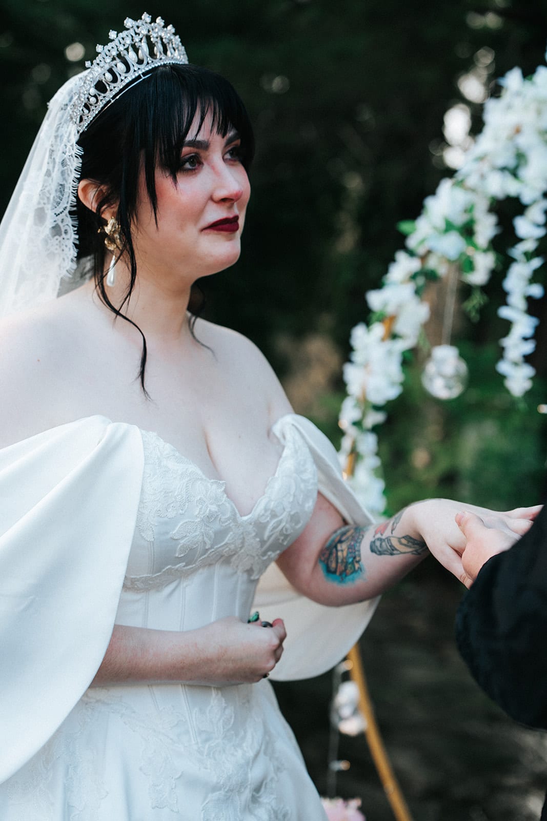 Porscha laughing as she reads her vows under the arch