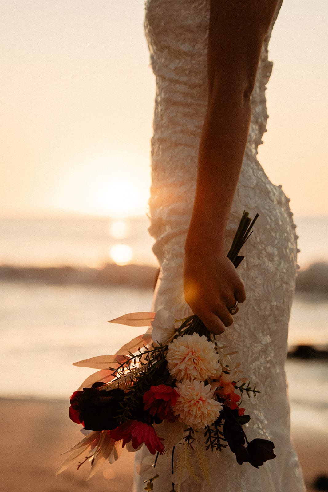 Close up of Sayuri’s bouquet and lace gown against the setting sun