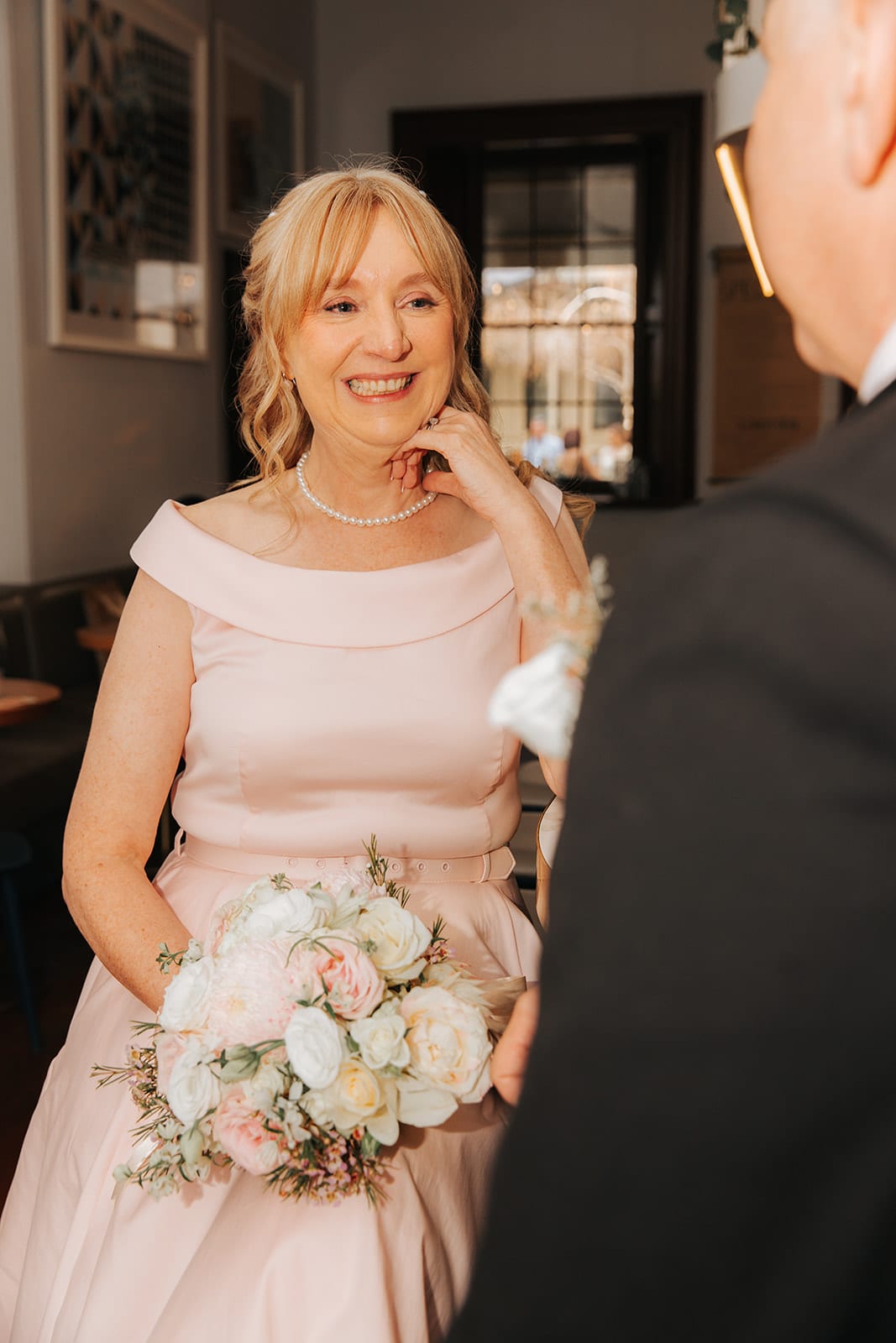 Terrie smiling at Jon with her hand at her chin in the bar at Treasury 1860