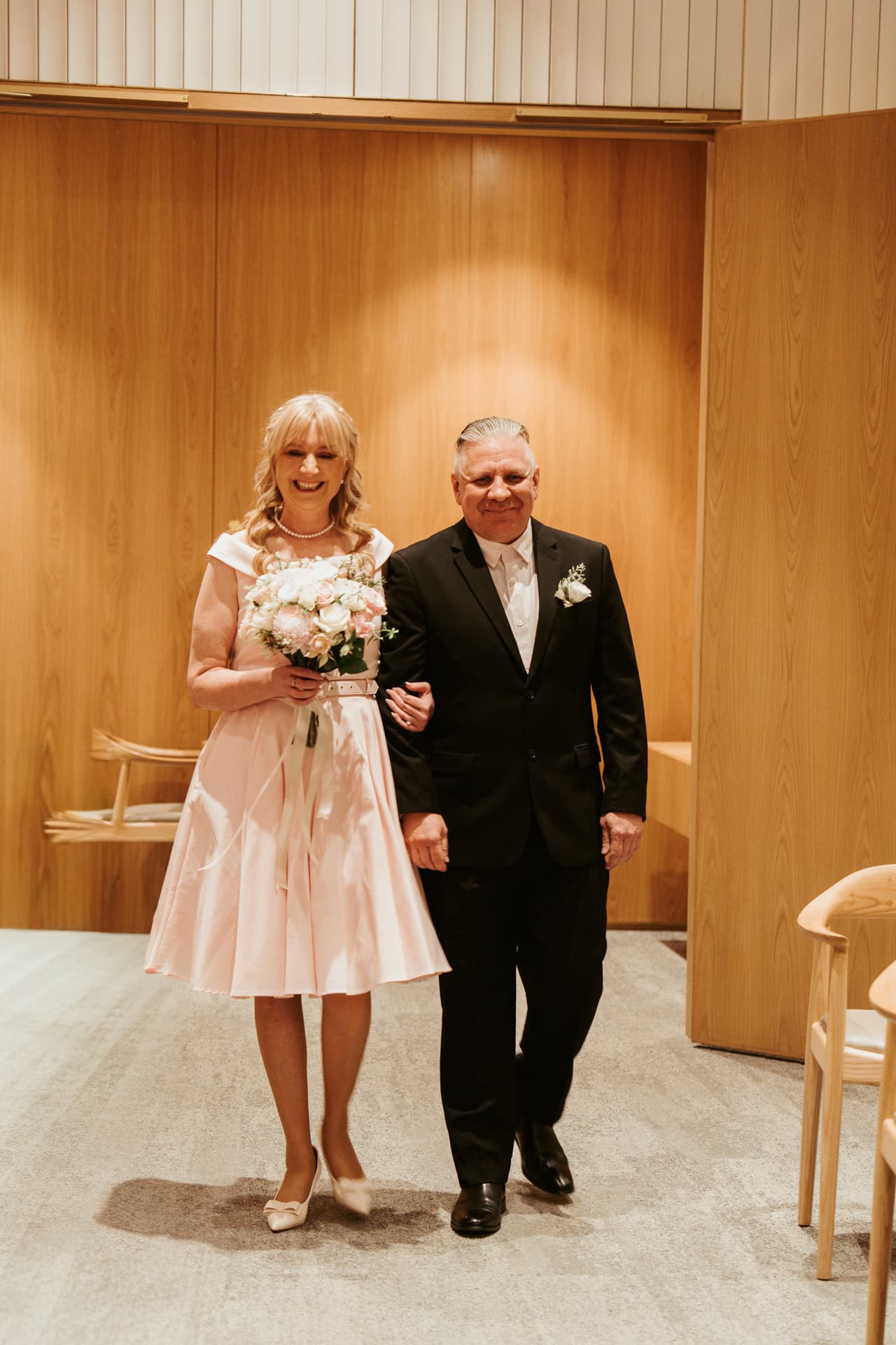 Terrie and Jon walking into the ceremony room at the registry office, arm in arm